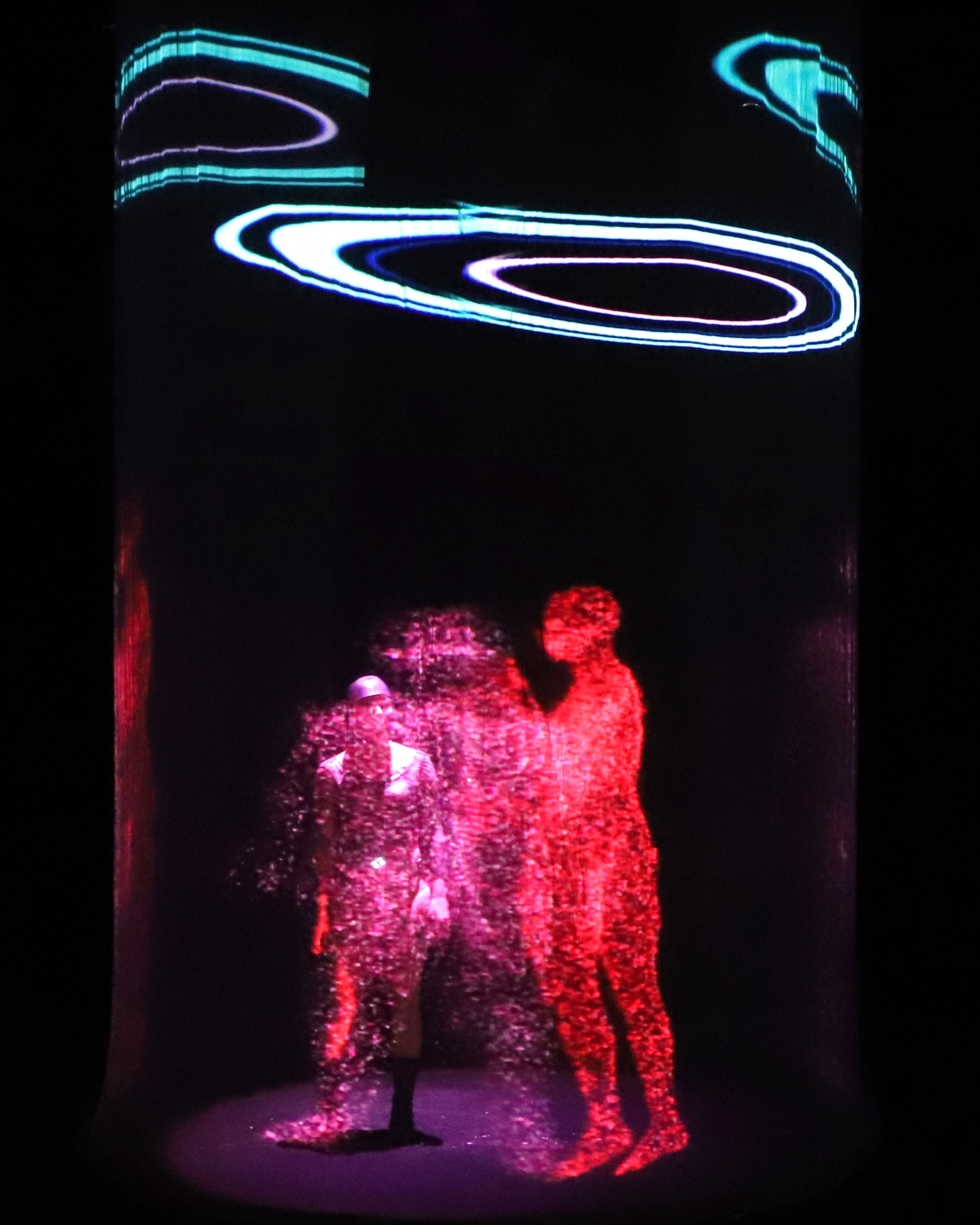 The Cyborg — Opera: particle figures inside a holographic cylinder